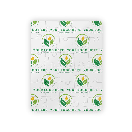 Customizable logo puzzle with green leaf design on a white background