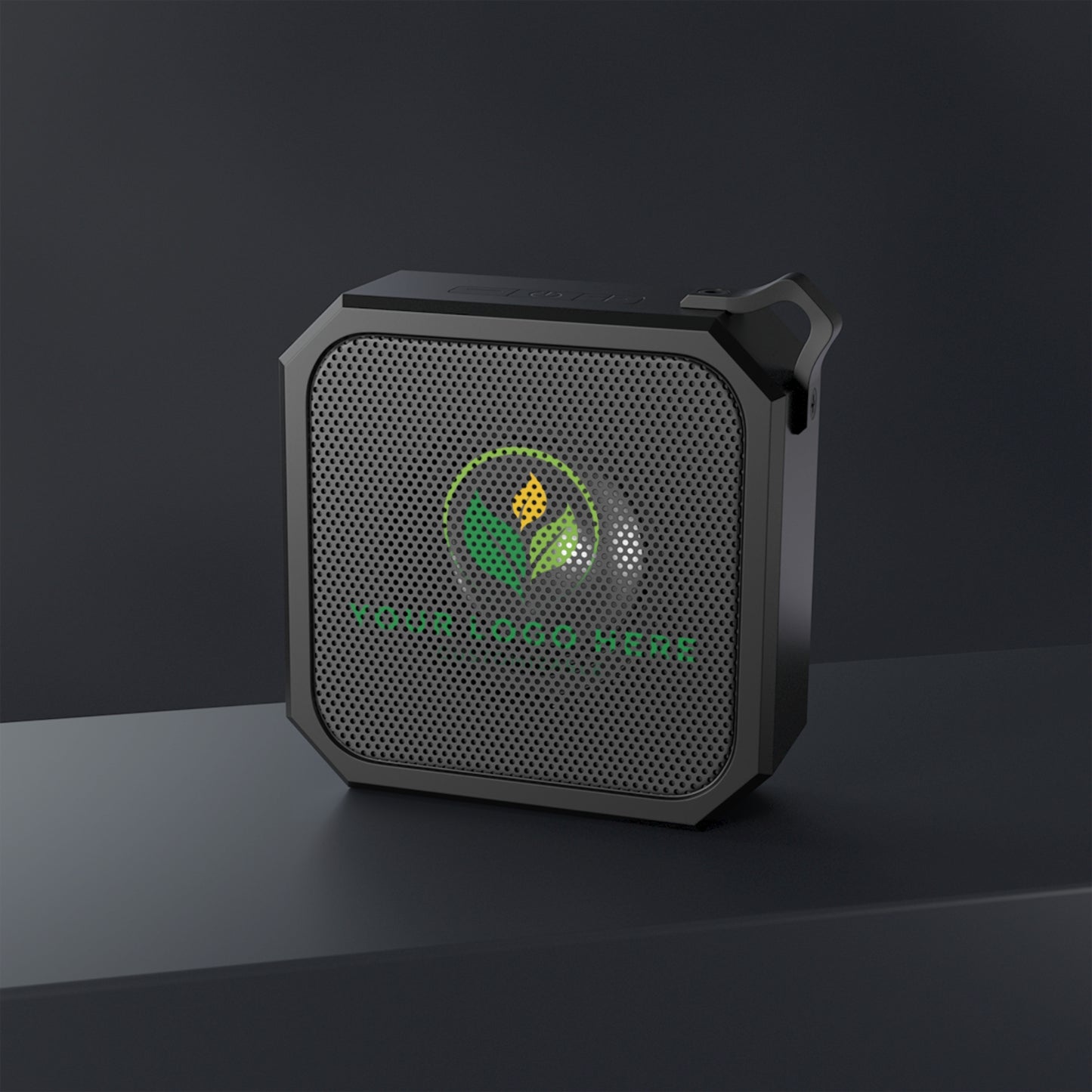 Black portable speaker with a logo on a dark background