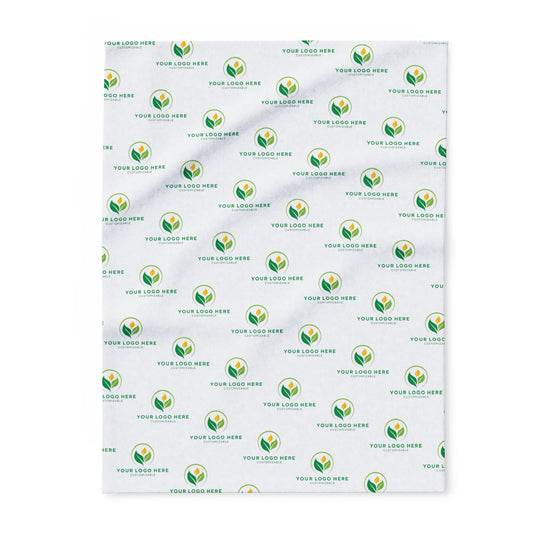 Patterned blanket with green and yellow logo repeats on a white background