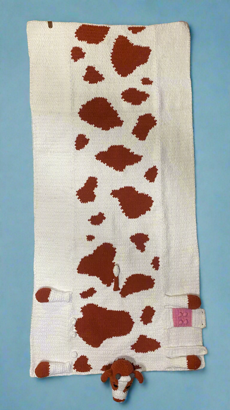 top view of adult size crochet cow, brown and white.