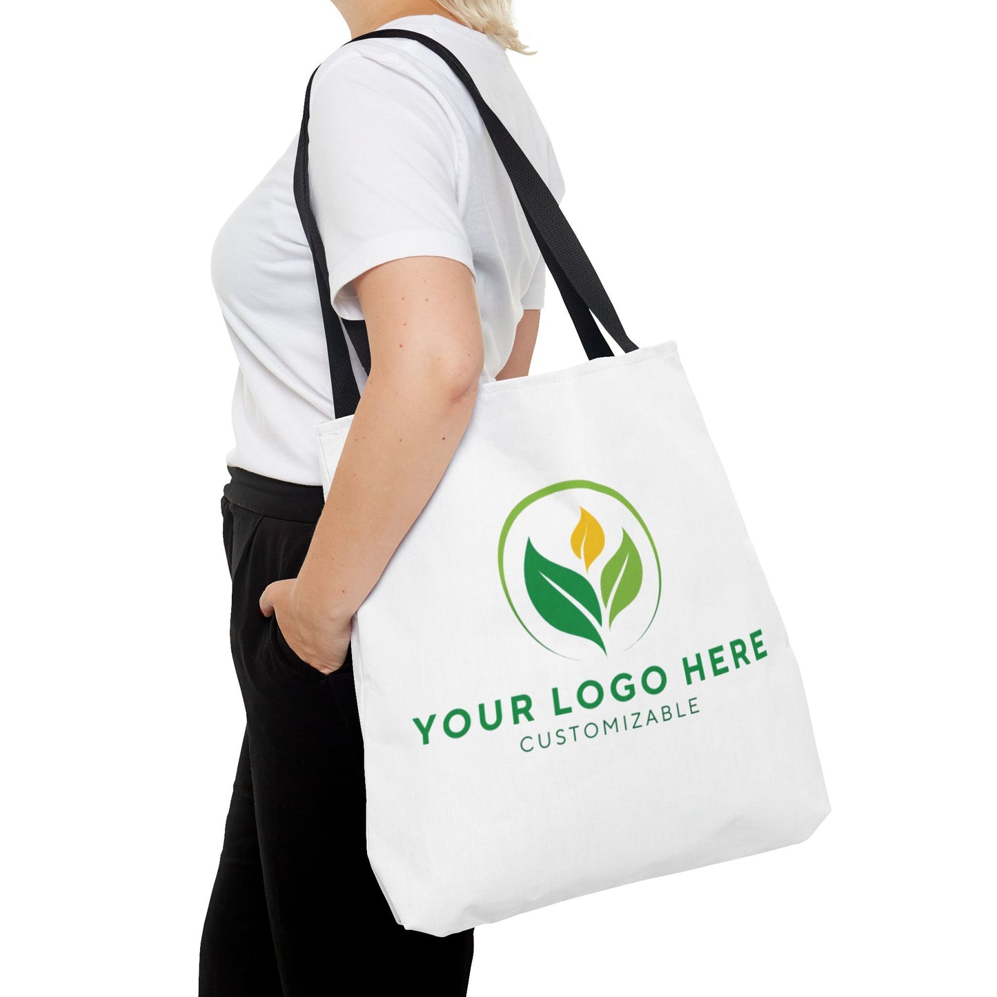 White tote bag with customizable logo design held by a person on a white background