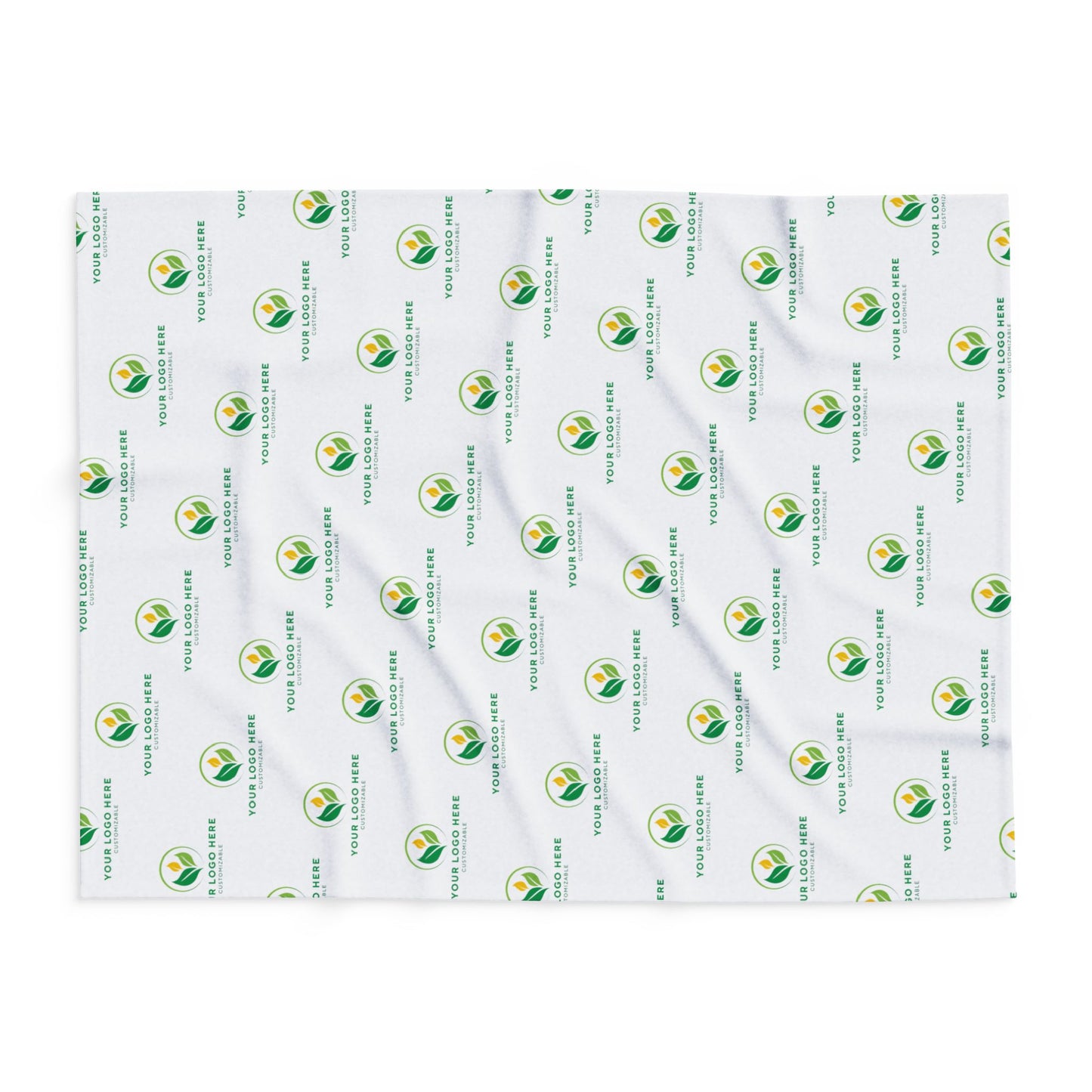 White blanket with green and yellow logo pattern on a white background