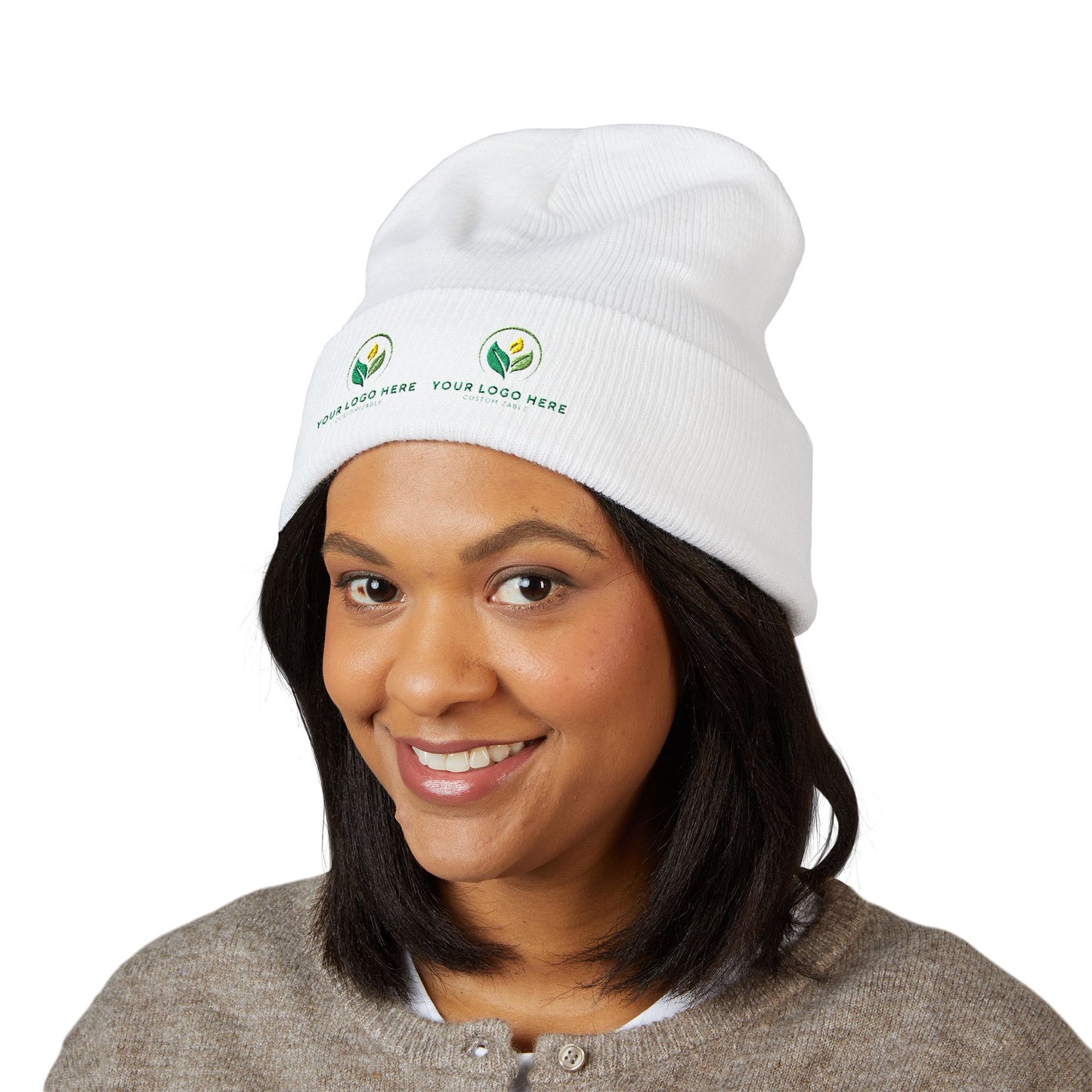 Woman wearing a white beanie with embroidered logos on a white background