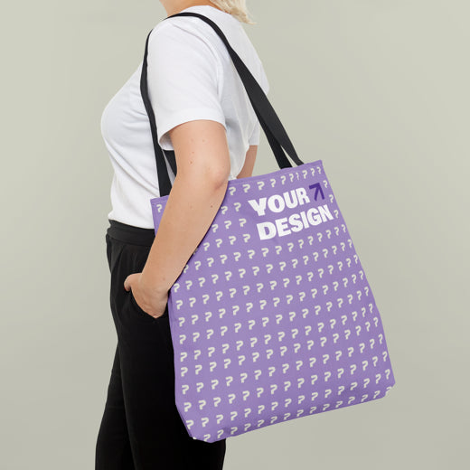 Person holding a purple tote bag with question marks and 'Your Design?' text.