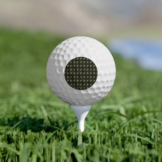 Golf ball on a tee in grass with a blurred background