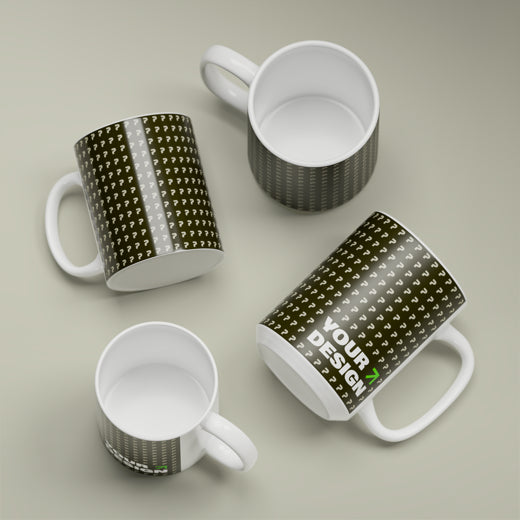 Four white mugs with black patterned designs on a beige background