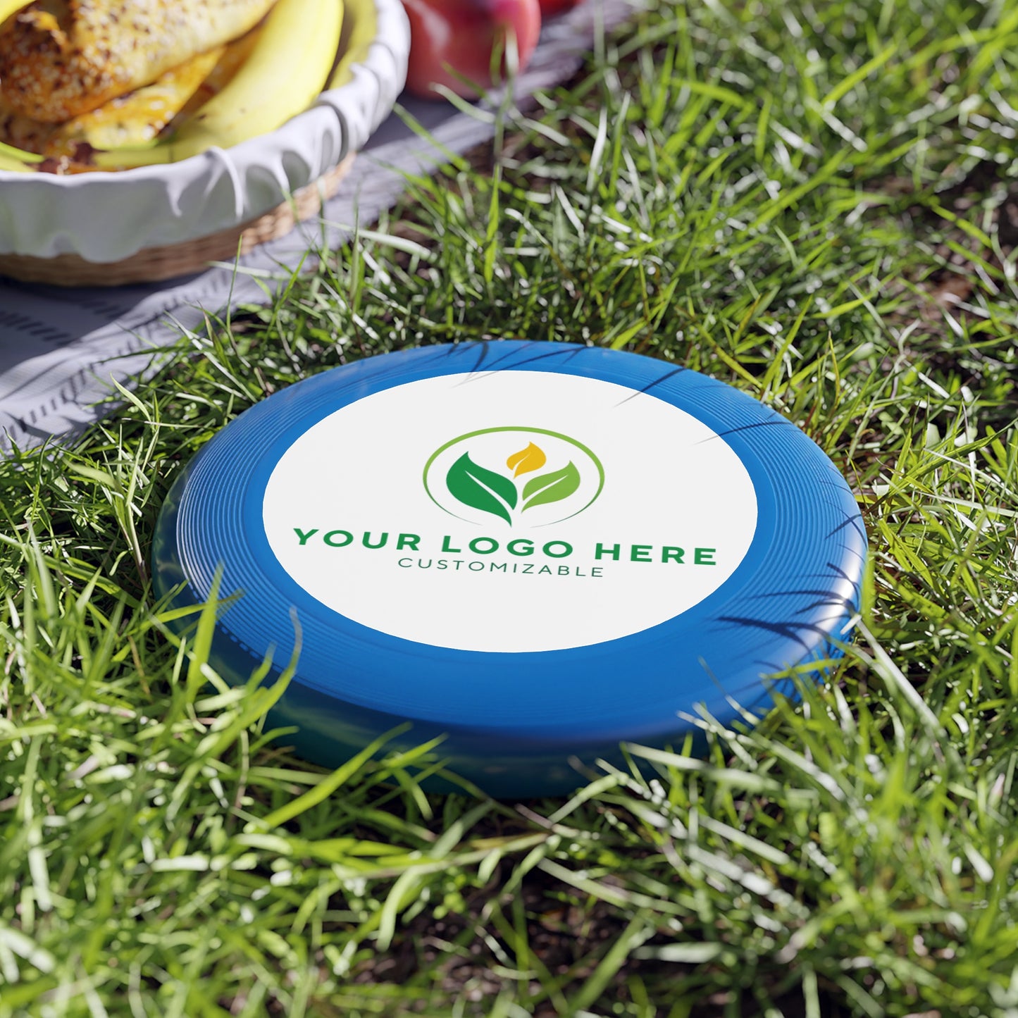 Blue frisbee with customizable logo on grass