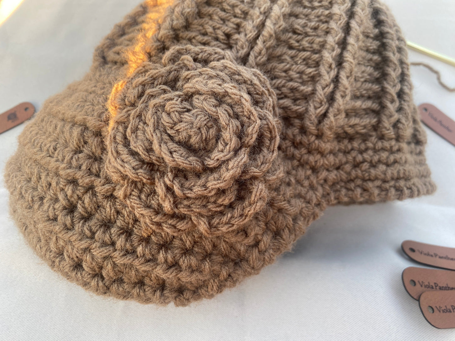 close up of brown crochet flower on hat