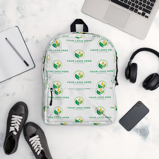 White backpack with green logo pattern on a white surface with accessories.