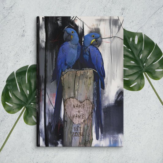 A custom canvas depicting two blue hyacinth macaws perched on a wooden stump with a custom name label, surrounded by a blurred background.