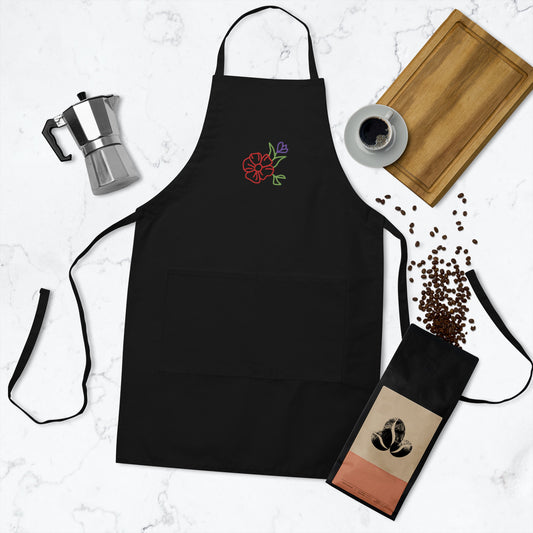 Black apron with floral embroidery on chest.