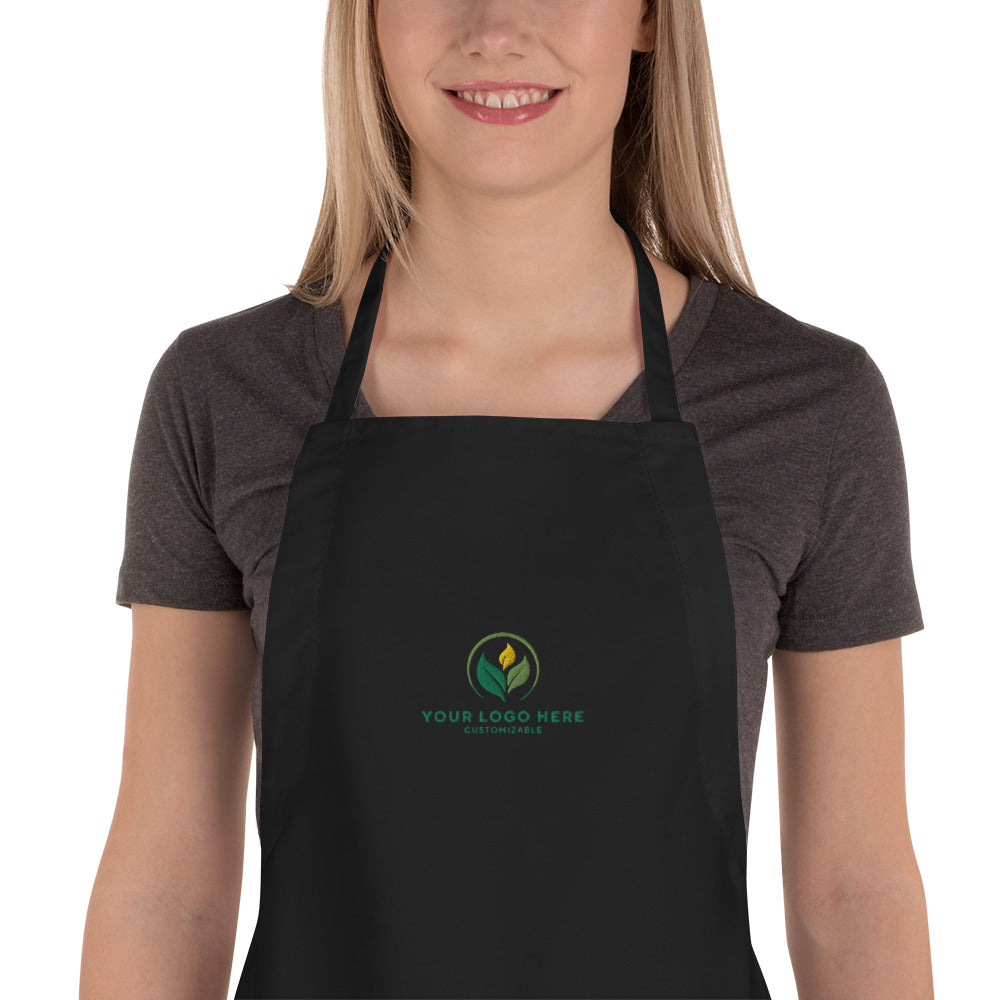 Person wearing a black apron with a customizable logo on a white background