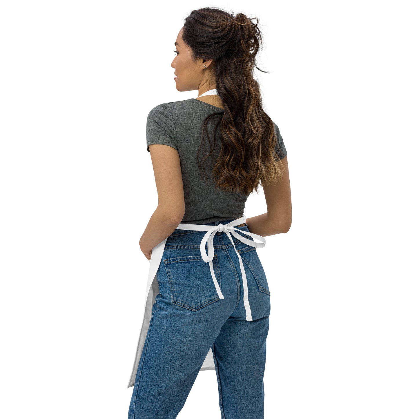 Back view of White apron with floral embroidery on chest.
