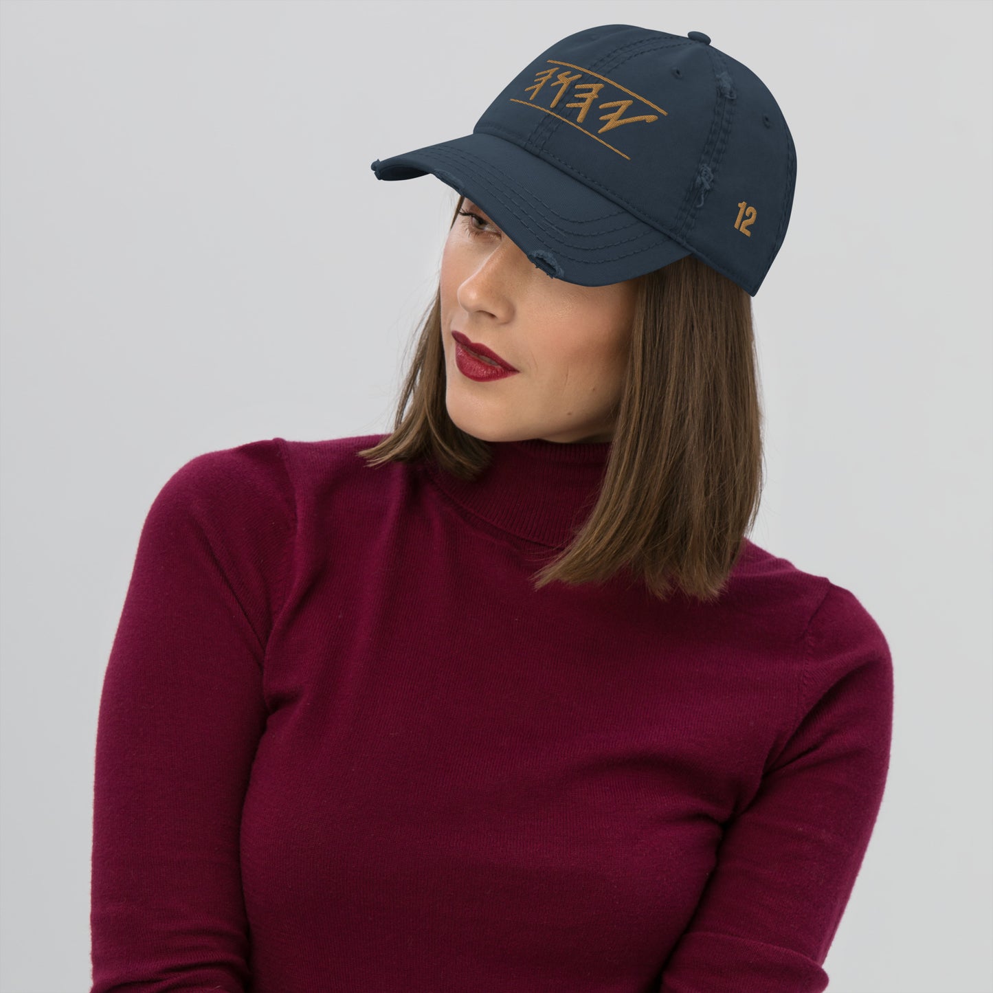 Woman wearing Distressed dad hat in black, khaki, navy, or charcoal featuring 'Yahuah' in Paleo‑Hebrew embroidered across the front in contrasting thread, with adjustable strap and worn‑in style.