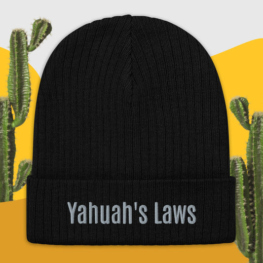 A black cuffed knit beanie with the text 'YAHUAH'S LAWS' printed in white on the fold.