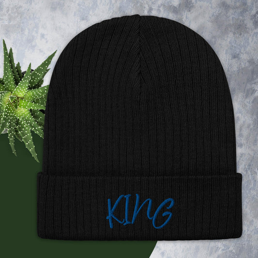 A black ribbed knit beanie with the word 'KING' written in blue on the cuff.