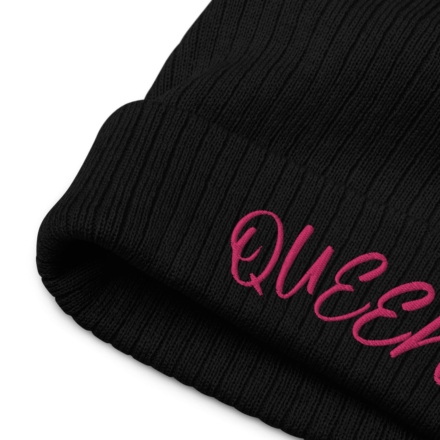 close up of the embroidery of the Queen ribbed knit beanie in blush pink, featuring a minimalist embroidered crown icon on the cuff, double-layer recycled polyester/acrylic knit, one-size-fits-most.