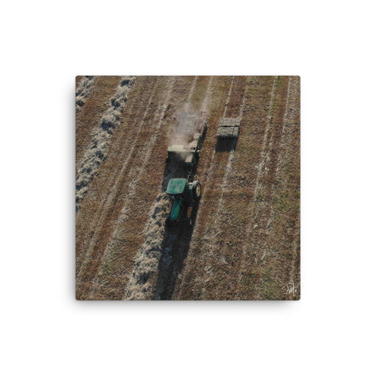 A canvas painting featuring a tractor in a field with a green background.