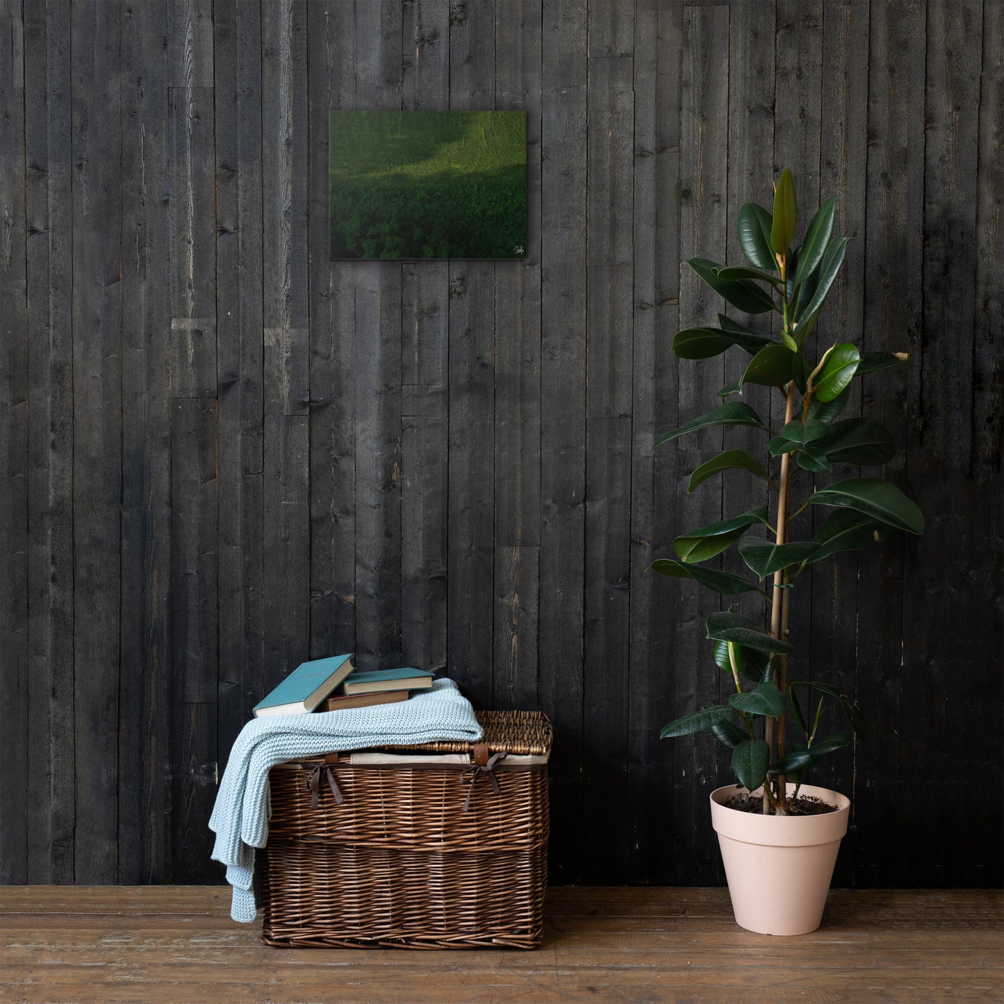 A canvas painting featuring a green and brown landscape, thin and with built-in wall mounts.