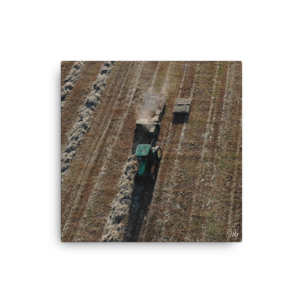 A canvas painting featuring a tractor in a field with a green background.