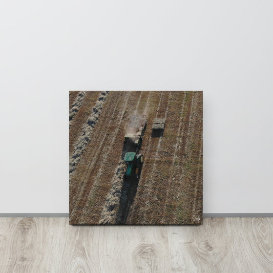 A canvas painting featuring a tractor in a field with a green background.