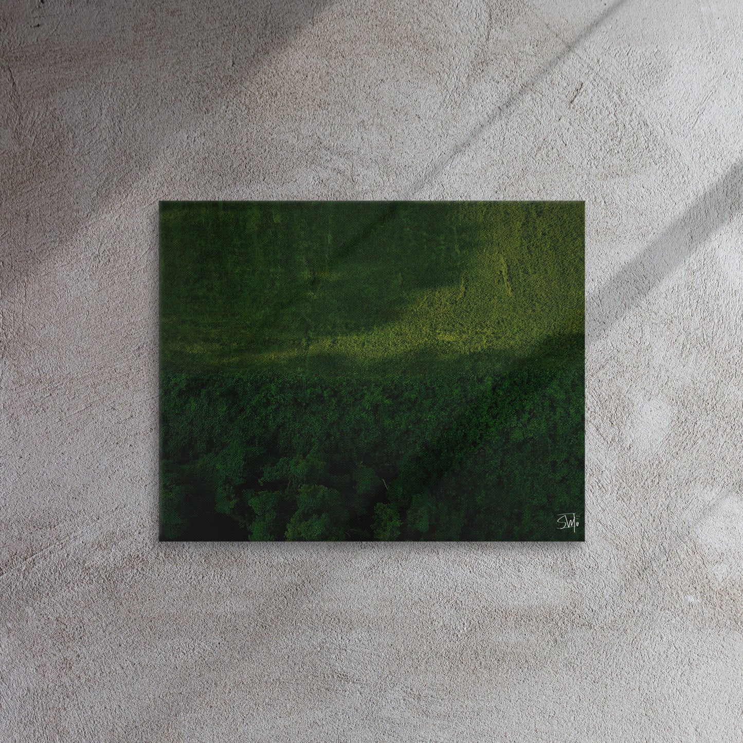A canvas painting featuring a green and brown landscape, thin and with built-in wall mounts.