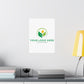 Customizable logo design on a white wall above a desk with books and a lamp.