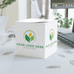 White cube with customizable logo on a desk with office supplies