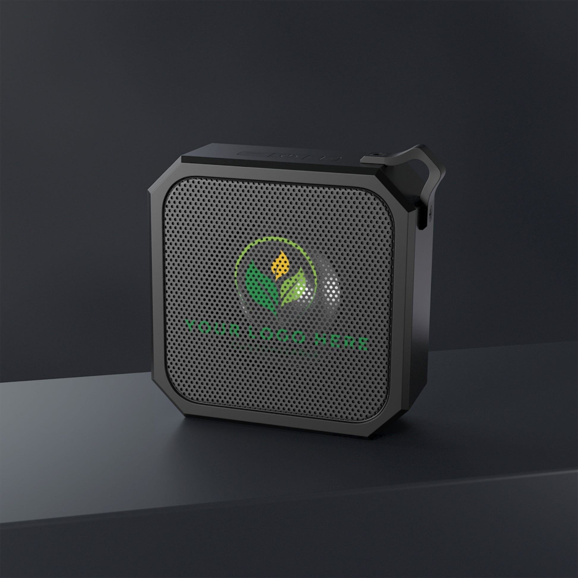 Black portable speaker with a logo on a dark background