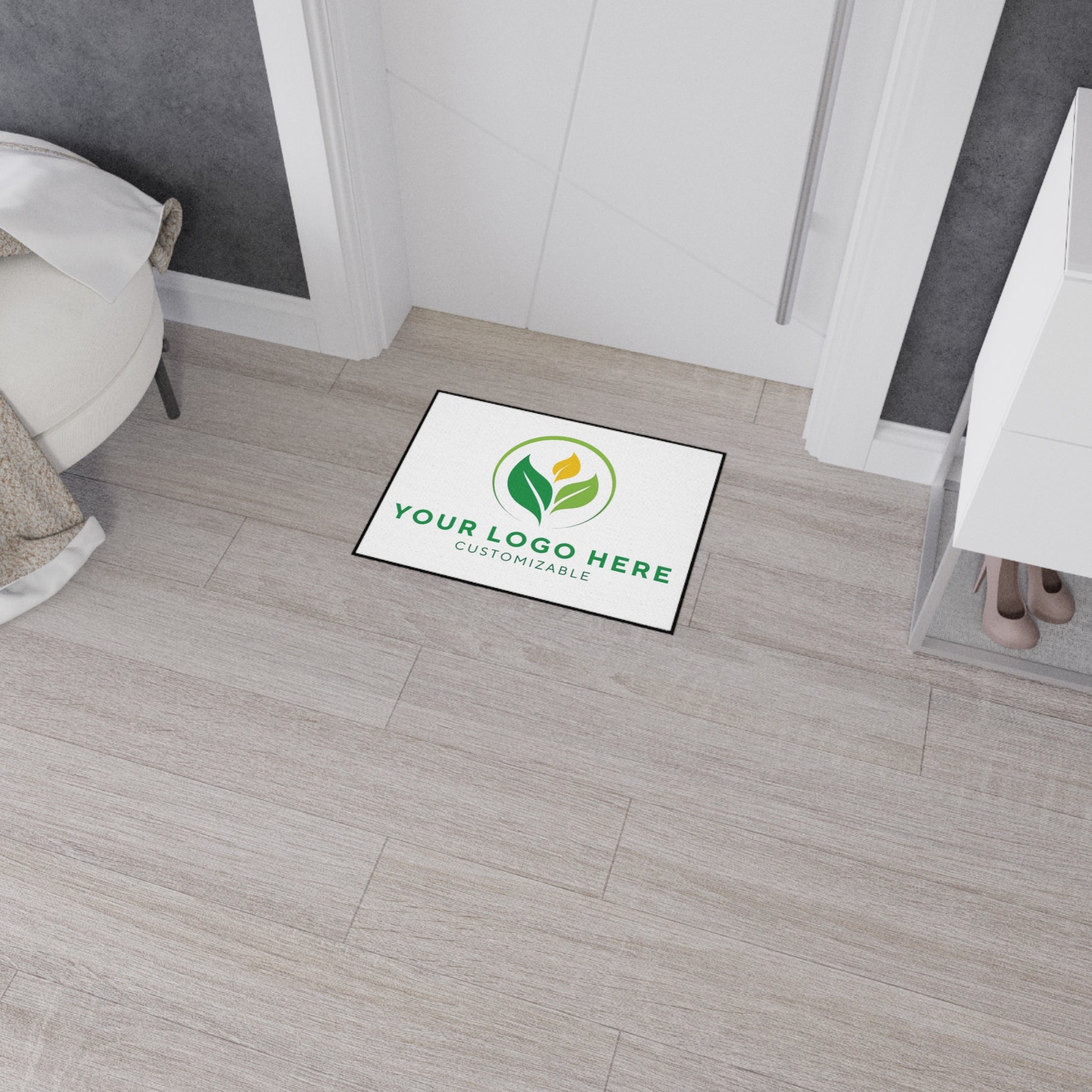 Customizable logo mat on a wooden floor with a room setting.