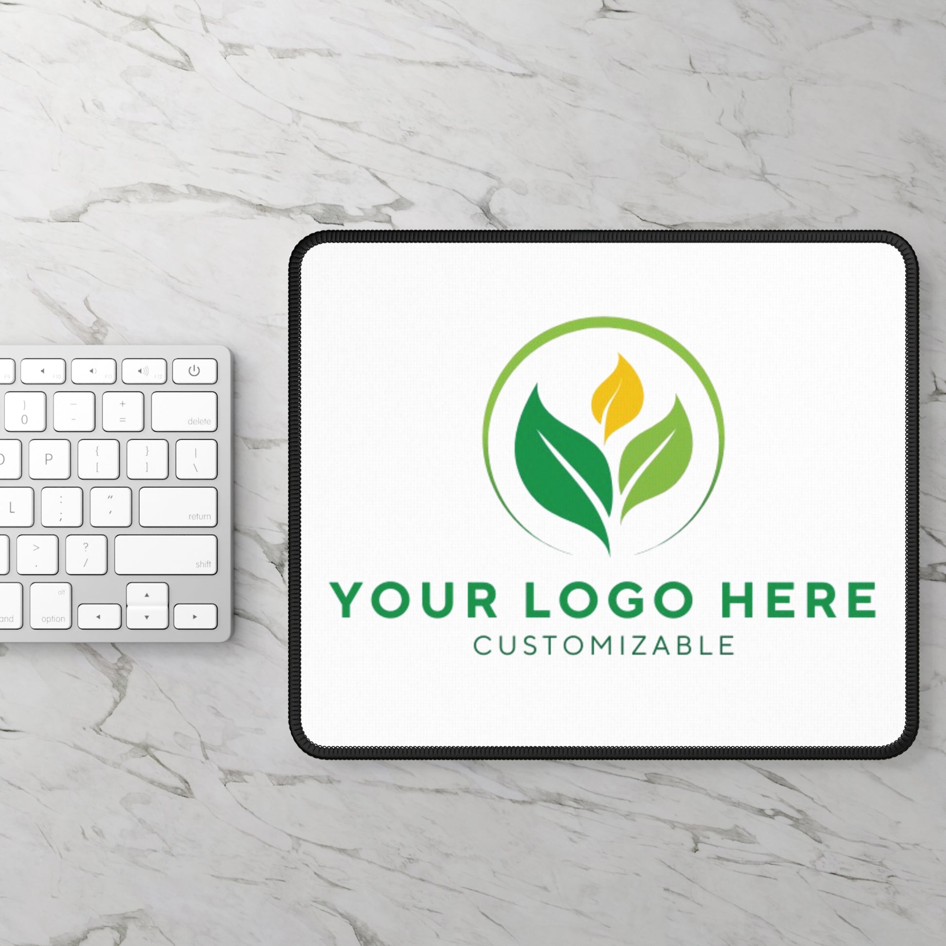 Tablet with customizable logo on a marble surface with keyboard