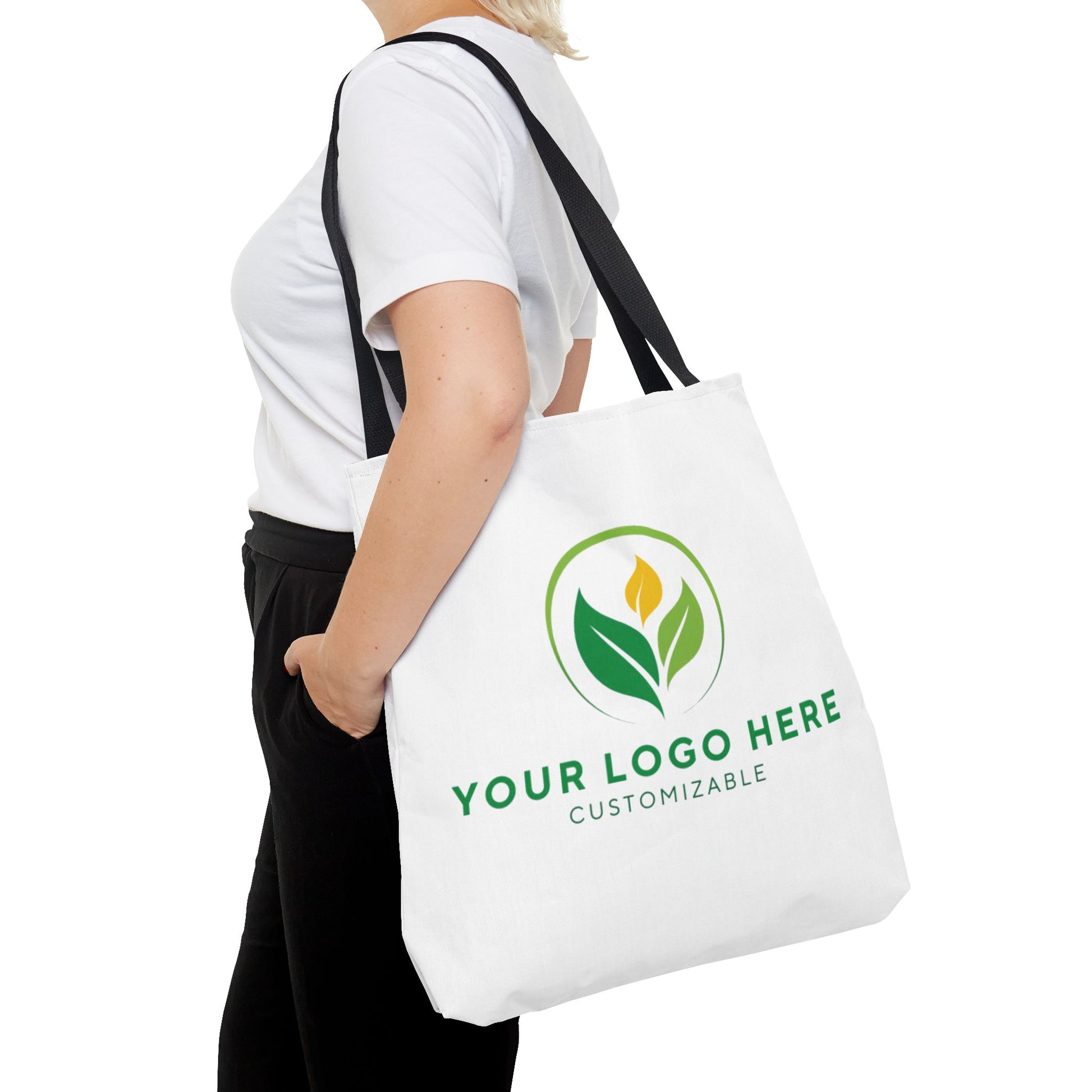 White tote bag with customizable logo design held by a person on a white background