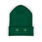 Green beanie with embroidered logos on a white background