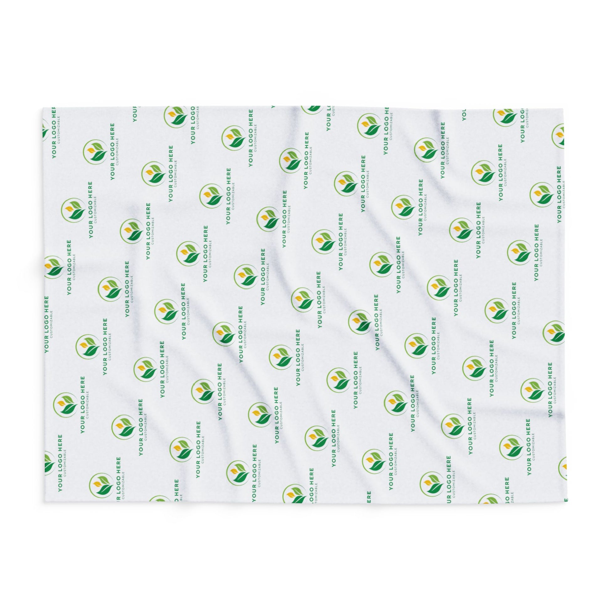 White blanket with green and yellow logo pattern on a white background