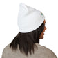 Person wearing a white beanie with a logo on a white background