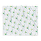 White blanket with green and yellow logo pattern on a white background