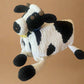 crochet cow toy on a beige surface