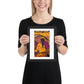 Person holding a framed artwork of a person in a colorful setting
