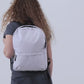 White backpack with customizable logo design on a white background